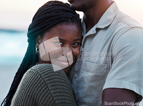 Image of Black couple, hug and portrait outdoor at beach with love, care and commitment or security. Smile on face of young african woman and man together on vacation, holiday or travel adventure in Jamaica