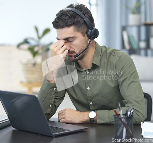 Image of Man, laptop and headache in call center, stress or debt in customer service or support at the office. Male person, consultant or agent with headphones and bad head pain in burnout at the workplace