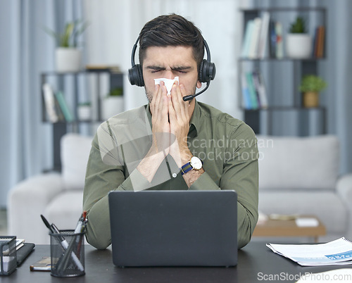 Image of Sick man, laptop and blowing nose in telemarketing or remote work with tissue at home office. Frustrated male person, consultant agent or freelancer with flu, virus or infection by computer in house