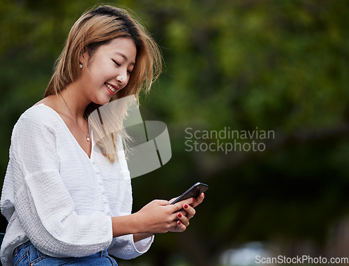 Image of Happy woman, mockup and typing with phone in garden, reading email, social media meme or text. Cellphone, internet search and Asian girl in park space checking mobile app with smile and chat online.