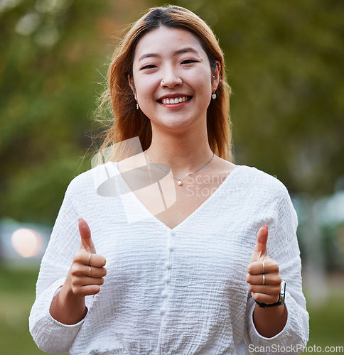 Image of Thumbs up, happy and portrait of Asian woman in park for support, relaxing and happiness outdoors. Smile, nature and face of female person with hand gesture for agreement, thank you and yes sign