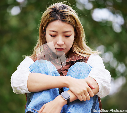 Image of Student, depression and thinking with woman in park for sad, college and anxiety. Mental health, psychology and burnout with asian person feeling lonely in nature for fatigue, pain and problem