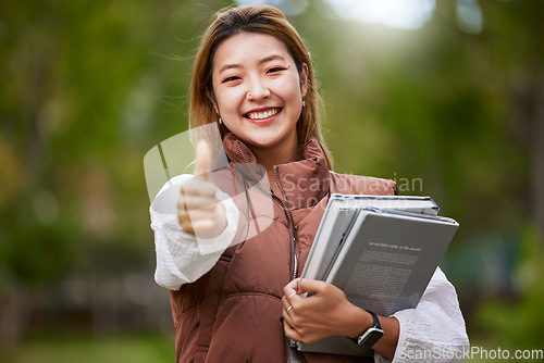 Image of Student, thumbs up and portrait of woman with books for learning, education and outdoor on university campus with happiness or pride. Happy, face and girl in college with notebook or walking to class