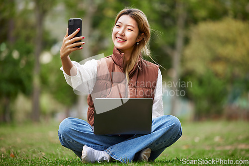 Image of Selfie, asian and woman student on video call in a park to connect to contact while outdoor studying online. Internet, laptop and young person or influencer takes picture in nature for peace and calm