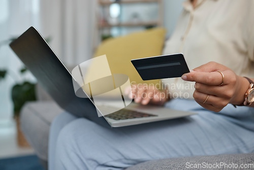 Image of Laptop, credit card in hand and online shopping with woman at home, fintech and payment of bills with internet banking. Female person on sofa, e commerce and pc, store website discount and finance