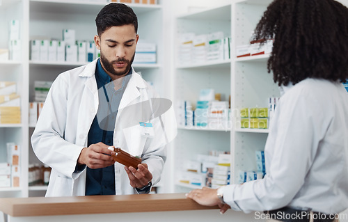 Image of Pharmacy, man and customer with medicine, instructions and conversation in drug store, medical supplements and prescription. Male employee, female client and pharmacist with antibiotics or healthcare