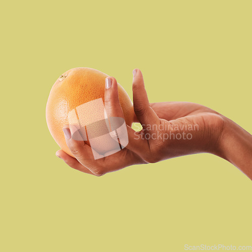 Image of Hands, orange and fruit for vitamin C, healthy diet plan or nutrition against a studio background. Hand holding fruity food, nectarine or grapefruit for health, organic wellness or citrus on mockup