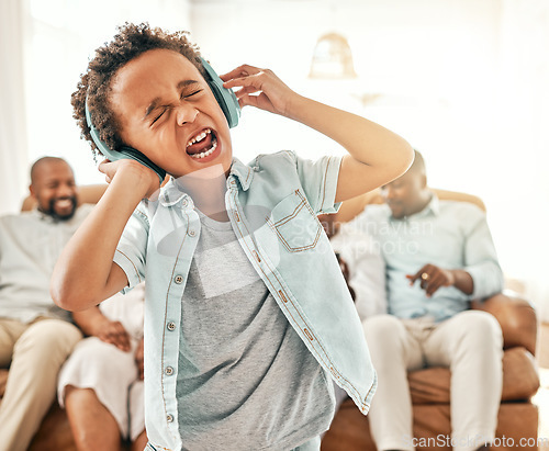 Image of Loud singing, child headphones and home with a young boy listening to music and web audio. House, family and kid streaming radio and a song with crazy, comedy and humor in the lounge yelling