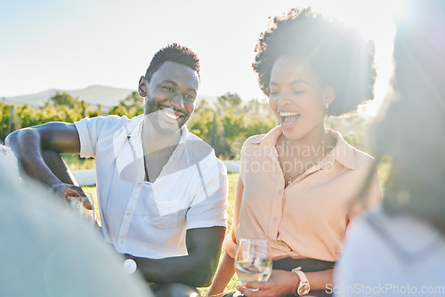 Image of Happy, wine or couple of friends at a picnic relaxing or bonding on a summer holiday vacation in nature. Smile, black woman and funny black man enjoying quality time and drinking alcohol in a park