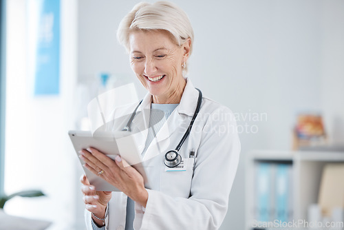 Image of Healthcare, tablet and senior doctor smile in hospital for online consulting, telehealth and wellness app. Clinic, insurance and woman on digital tech for internet, medical research or patient data