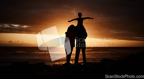 Image of Sunset, beach and silhouette of parents with child by ocean for bonding, quality time and peace. Happy family, nature and back of mother, father and kid on shoulder on vacation, holiday and weekend