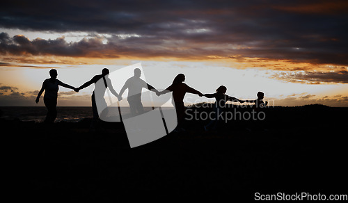 Image of Sunset, beach and silhouette of family with children by ocean for bonding, quality time and peace. Shadow, nature and grandparents, parents and kids holding hands on vacation, holiday and weekend