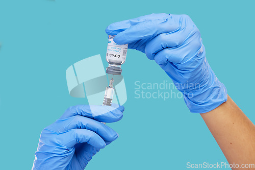 Image of Mockup, closeup and hands with needle, vial and vaccination for diagnosis against a blue studio background. Zoom, hands and gloves, with medicine, cure and vaccination for medical diagnosis or result