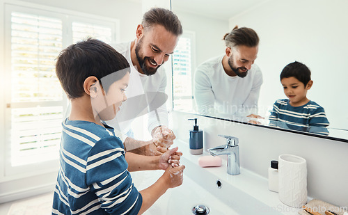 Image of Cleaning, washing hands and father with boy in bathroom for hygiene, wellness and healthcare at home. Family, skincare and dad with child learning to wash with water, soap and disinfection by faucet