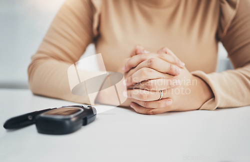 Image of Hands, anxiety and diabetes with a woman waiting for the results of a test while sitting at a table. Healthcare, blood and equipment with a female diabetic testing her sugar or glucose level