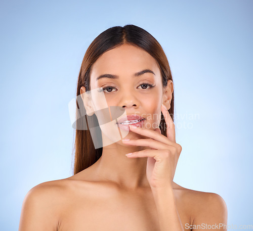 Image of Skincare, dermatology and portrait of woman beauty with smooth clear skin due to facial isolated in a studio blue background. Soft, natural and clean model due to self care as cosmetic treatment