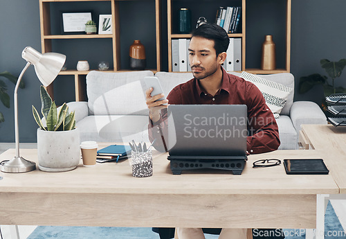 Image of Asian man, phone and texting in office for email communication, corporate schedule and laptop. Entrepreneur, businessman or focus with smartphone for networking, tech and web chat app with digital ux