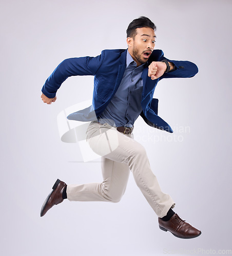 Image of Wristwatch, jump and Asian man late, appointment and employee against a grey studio background. Male manager, consultant and employee with schedule, deadline and stress with clock, jump and movement