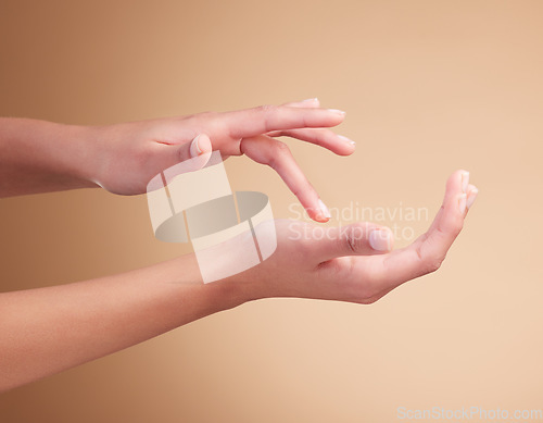 Image of Hands, manicure and palm beauty of female model with cosmetic care, skincare or self care isolated in brown studio background. Polish, shine and nails with natural glow and healthy skin