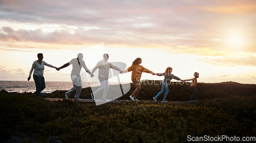 Image of Family holding hands and walking in nature for group support, growth development and adventure together in sunset. Children with grandparents for fitness, health and running by a park path or ocean