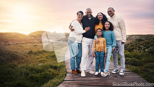 Image of Happy family, portrait and people on vacation or holiday smile on a boardwalk and embrace together during sunset. Trip, getaway and grandparents with parents and children or kids bonding