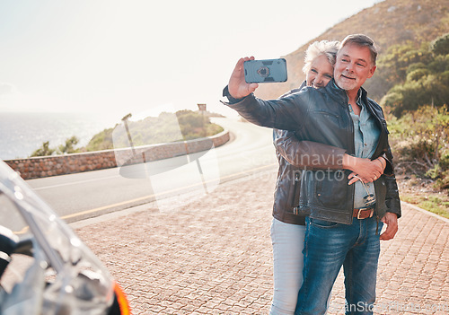 Image of Mountain, bikers and couple taking a selfie together while on an adventure, vacation or weekend trip. Freedom, nature and senior man and woman in retirement taking a picture while on a motorbike ride