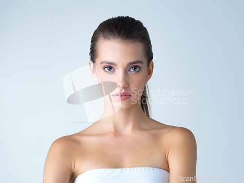 Image of Beauty, skincare and makeup, portrait of woman in studio isolated on blue background salon cosmetics. Serious face of beautiful model from Ukraine, spa facial and treatment for fresh, clean skin glow