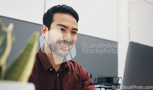 Image of Face, happy and laptop with a business man in the office, working on a company project while sitting at his desk. Computer, smile and mission with a male employee typing an email or report at work