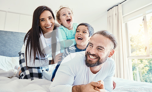 Image of Portrait, family and laughing on bed in home, having fun and bonding together. Comic, love and care of happy father, mother and kids or boys playing, smile and enjoying quality time in house bedroom.
