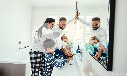 Image of Family, washing hands and bathroom with a mom, father and children with hygiene care in morning. Mother, kids and dad together with love, support and youth in a home doing self care at a sink