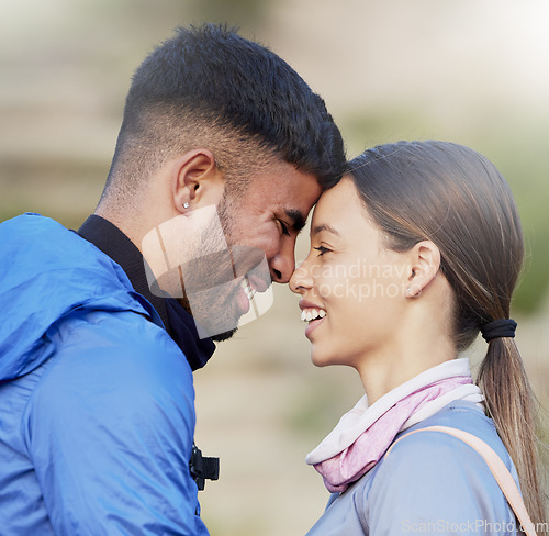 Image of Man, woman and forehead touch for hiking, love and happiness in nature for outdoor adventure on holiday. Young happy couple, training and smile with care, bonding and vacation in countryside together