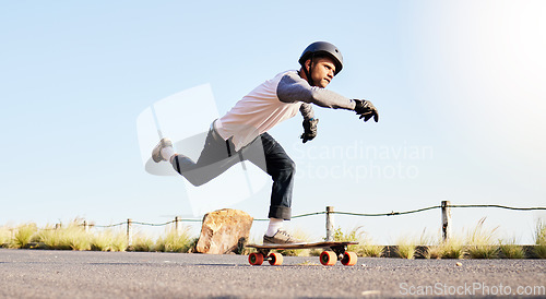 Image of Skateboard, sports action and man in road for competition, training and exercise challenge in city. Skating, skateboarding and male skater with focus for speed, adventure and freedom in extreme sport