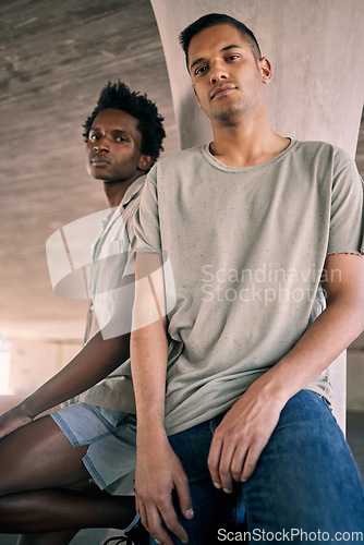 Image of Portrait, fashion and diversity with friends in an urban city together for grunge style on a concrete background. Confident, streetwear and gen z with cool young men sitting in a town to relax