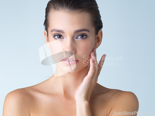 Image of Skincare, cosmetics and portrait of young woman in studio isolated on blue background in salon makeup. Beauty, portrait of model from Spain and spa facial treatment for fresh clean skin with mockup.