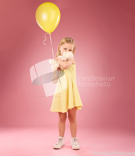 Image of Teddy bear kiss, balloon and girl portrait with a soft toy with happiness and love for toys in a studio. Isolated, pink background and a young female child feeling happy, joy and cheerful with friend