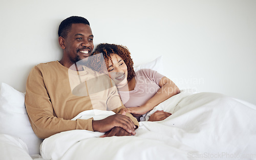 Image of Black couple, bedroom tv watching and bed rest in the morning together with love and care. Happiness, home and smile of a woman and man feeling happy about streaming a movie in a house with bonding