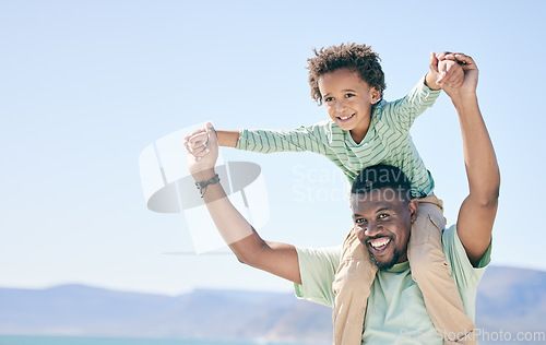 Image of Black family, man and a son sitting on shoulders while outdoor in nature together during a beach vacation. Love, sky or kids with a father or parent carrying his child while walking on the coast