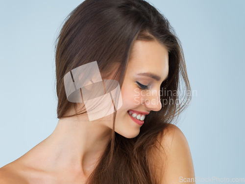 Image of Skincare, cosmetics and woman with smile, beauty and dermatology on blue studio background. Female, lady and confidence with morning routine, grooming and luxury salon treatment, soft and smooth skin