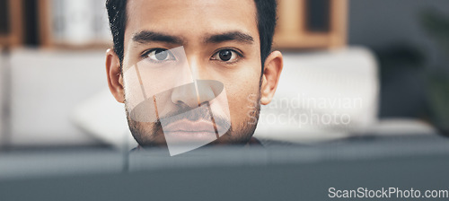 Image of Face, focus and a business man at work on a computer in his office closeup for the company mission. Eyes, mindset and serious with a young male employee working on a desktop pc for administration