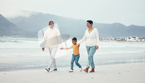 Image of Grandfather, grandma and child walking on beach enjoying holiday, travel vacation and weekend together. Big family, nature and happy grandparents holding hands for bonding, quality time and relax