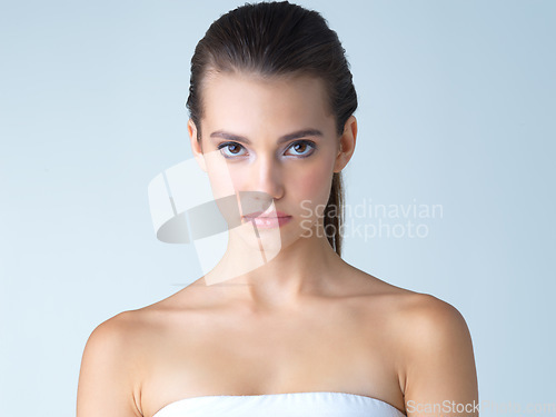 Image of Beauty, skincare and serious portrait of woman in studio isolated on blue background salon cosmetics. Face of beautiful model from Ukraine, spa facial and treatment for fresh, clean skin glow makeup.