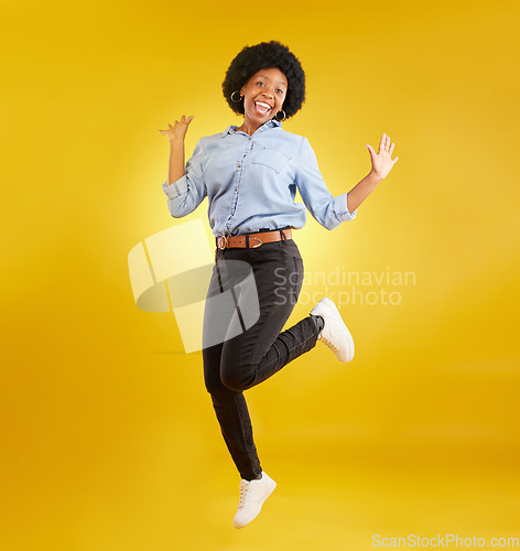 Image of Jump, excited and portrait of black woman on yellow background with energy, happiness and smile in studio. Winner mockup, celebration and isolated happy girl jumping for freedom, winning and success