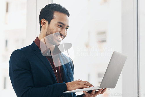 Image of Corporate asian man, laptop typing and smile in office for email communication, chat or social media. Entrepreneur, businessman and happy with computer for web design, chat or funny meme on internet