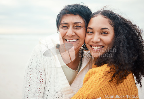 Image of Happy, hug and portrait of a mother and daughter at the beach for travel, bonding and vacation. Family, smile and elderly mom with an adult woman at the ocean to relax together for happiness