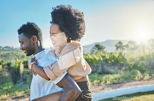 Image of Love, black couple and piggy back in countryside, travelling and bonding for vacation, relationship and break. Romance, man carry woman and loving on weekend, holiday and honeymoon to relax and smile
