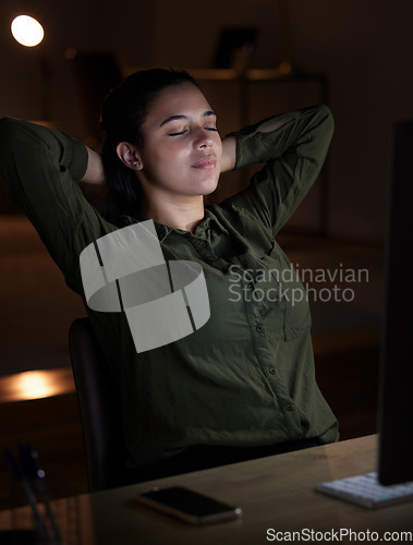 Image of Night, relax and overtime with a business woman in her office, sitting hands behind head after a late shift. Peace, quiet and calm with a young female resting in the workplace after a deadline