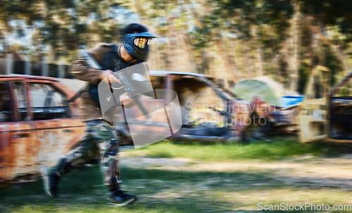 Image of Man, paintball and rush for intense battle or war in the forest running to attack on grass field. Male paintballer or soldier moving fast to push enemy defense in extreme adrenaline sports outdoors