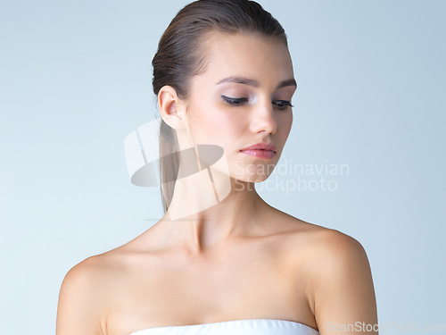 Image of Beauty, skincare and serious face of woman in studio isolated on blue background salon makeup. Cosmetics, beautiful model from Germany, spa facial and treatment for fresh, clean skin glow with mockup