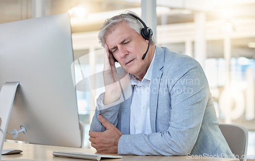Image of Call center, customer service and headache with a consultant man suffering from pain while working in the office. Crm, support and burnout with a senior male telemarketing working feeling stress