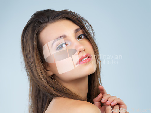 Image of Cosmetics, beauty and portrait of woman with makeup on blue background for wellness, skincare and spa treatment. Salon aesthetic, dermatology and face of girl with cosmetics, confidence and facial